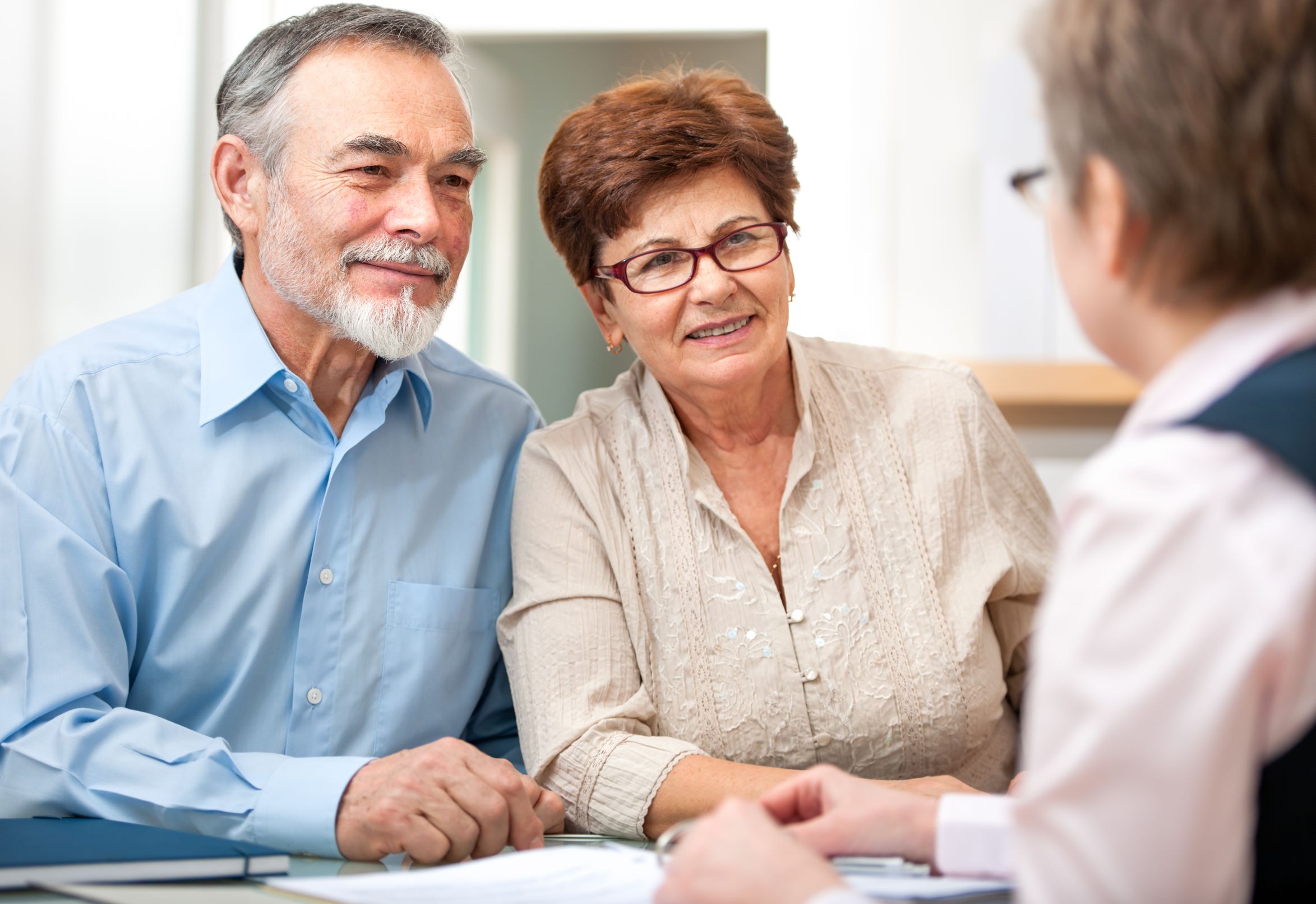 Senior couple meets with an elder law attorney to discuss Medicaid planning.